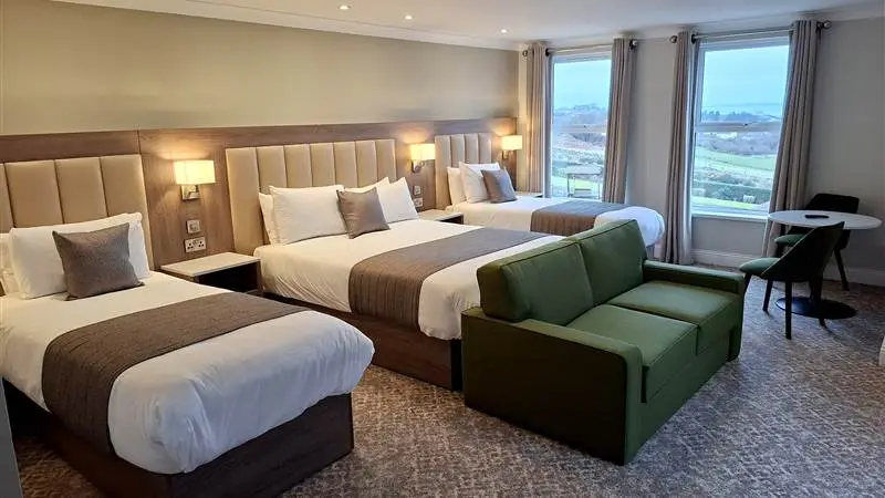 Guest room at Ballyliffin Lodge and Spa with three beds and a view over the landscape